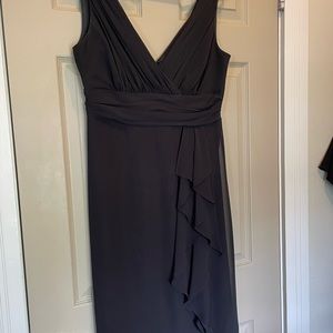 Black sleeveless special occasion dress with high rise and pleated bodice.